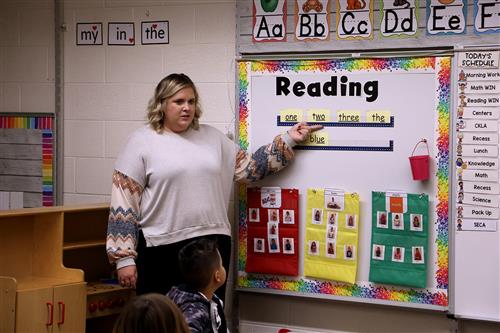 teacher pointing to board